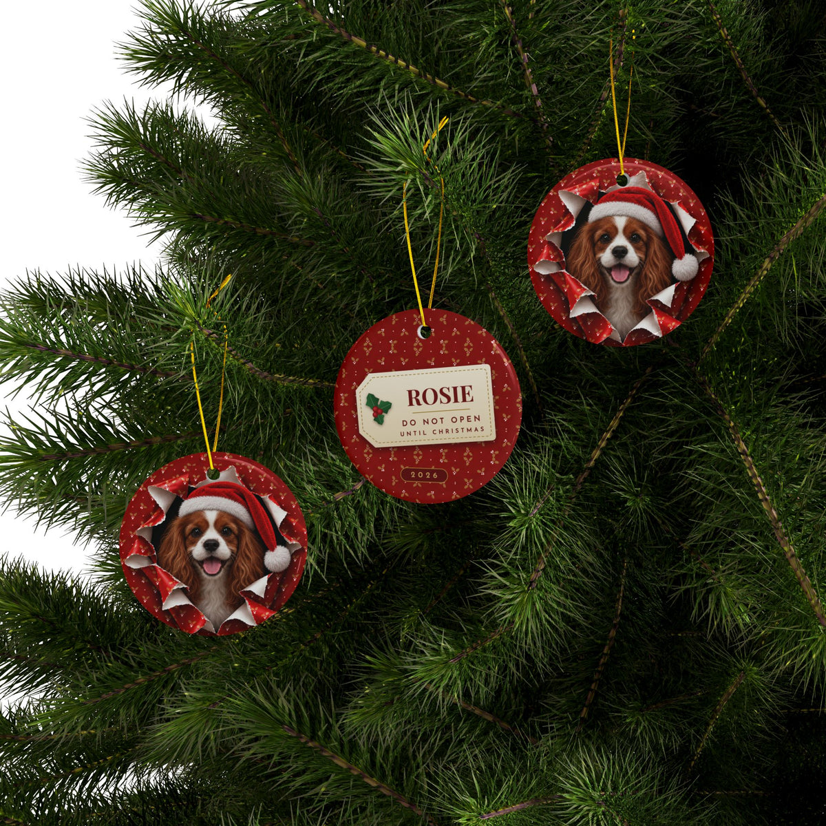 Three Cavalier King Charles ornaments hanging on a Christmas tree